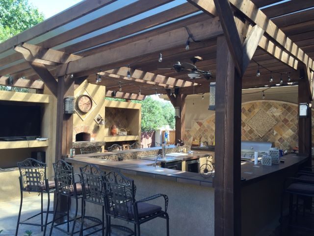 Finished patio cover shading an outdoor kitchen and dining area